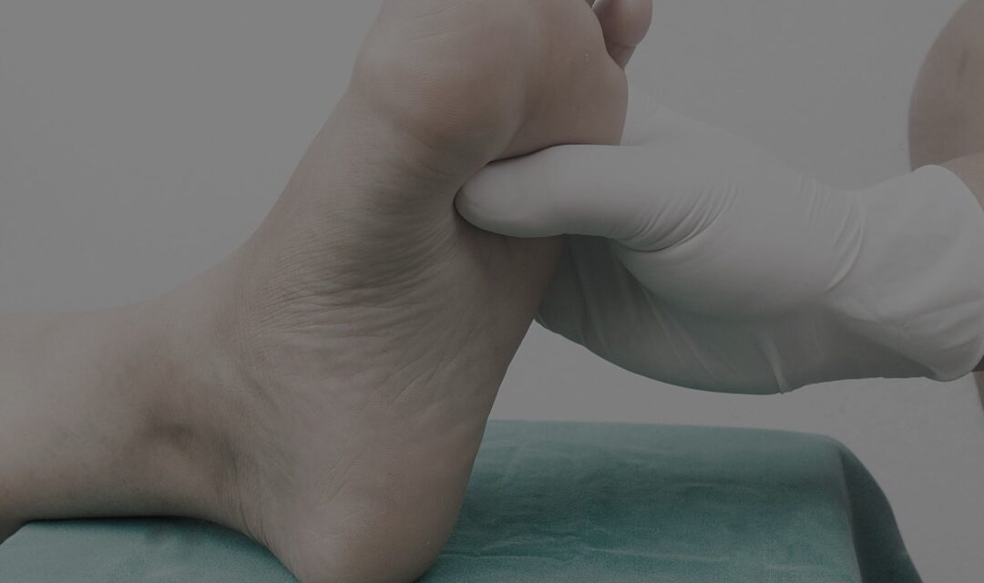Podiatrist examining a patient's foot for pain or injury.