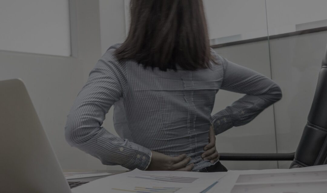 Woman consulting with a doctor about pain management options in an office setting.