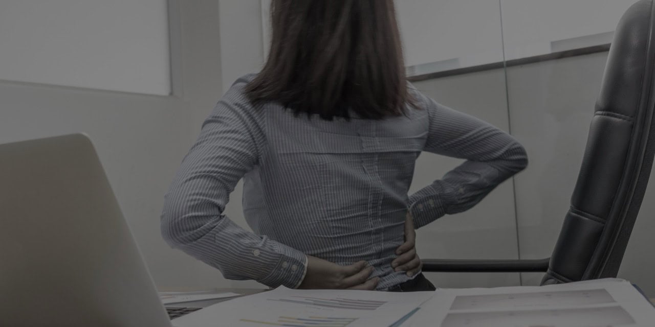 Woman consulting with a doctor about pain management options in an office setting.